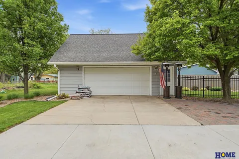 207 W 4th Street: detached 2-stall garage off the drive, with black metal fencing