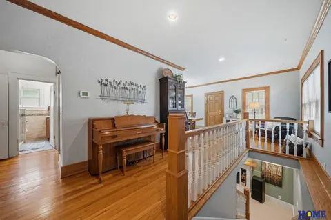 207 W 4th Street: front of the main floor with the open stair rail and white balusters