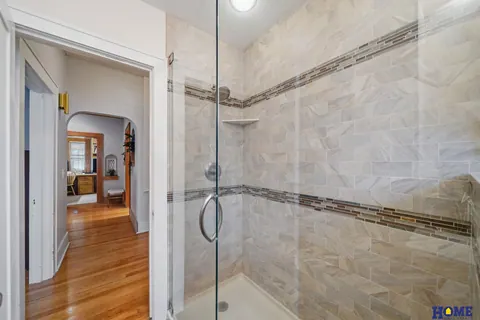 207 W 4th Street: main-floor bath with a frameless glass walk-in shower