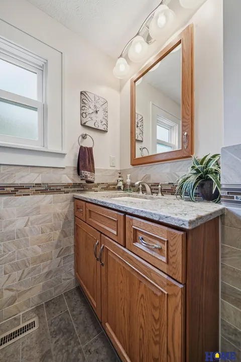 207 W 4th Street: main-floor bath vanity with oak cabinets