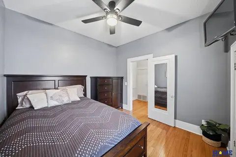 207 W 4th Street: main-floor bedroom with French doors and a ceiling fan