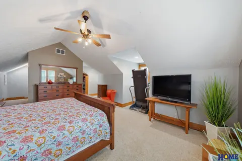 207 W 4th Street: primary bedroom on the second floor with a vaulted ceiling