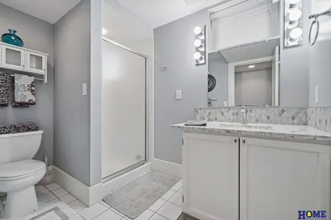 207 W 4th Street: basement bath with a white vanity