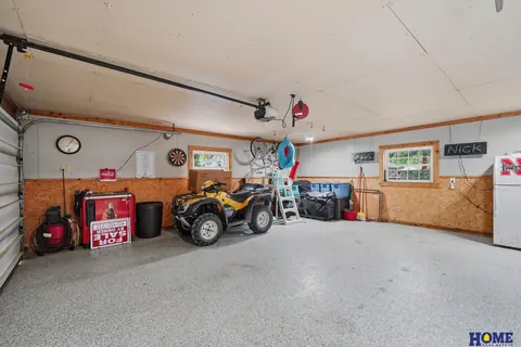 207 W 4th Street: attached 2-stall garage with an epoxy floor and wood wainscot, photo 53