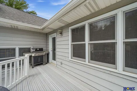 207 W 4th Street: back deck along the house with white railings