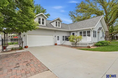 207 W 4th Street: paver-edged drive and attached garage with dormers above