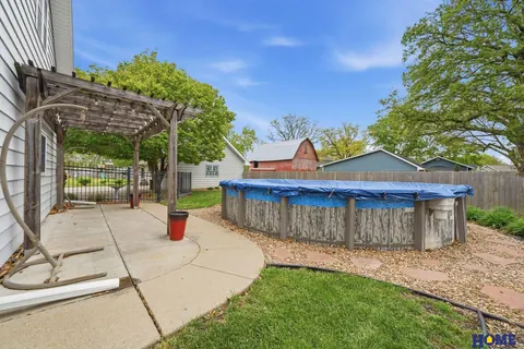 207 W 4th Street: concrete patio toward the above-ground pool