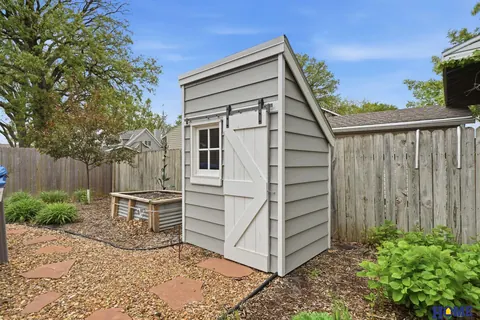 207 W 4th Street: shed and wood privacy fence in the back yard
