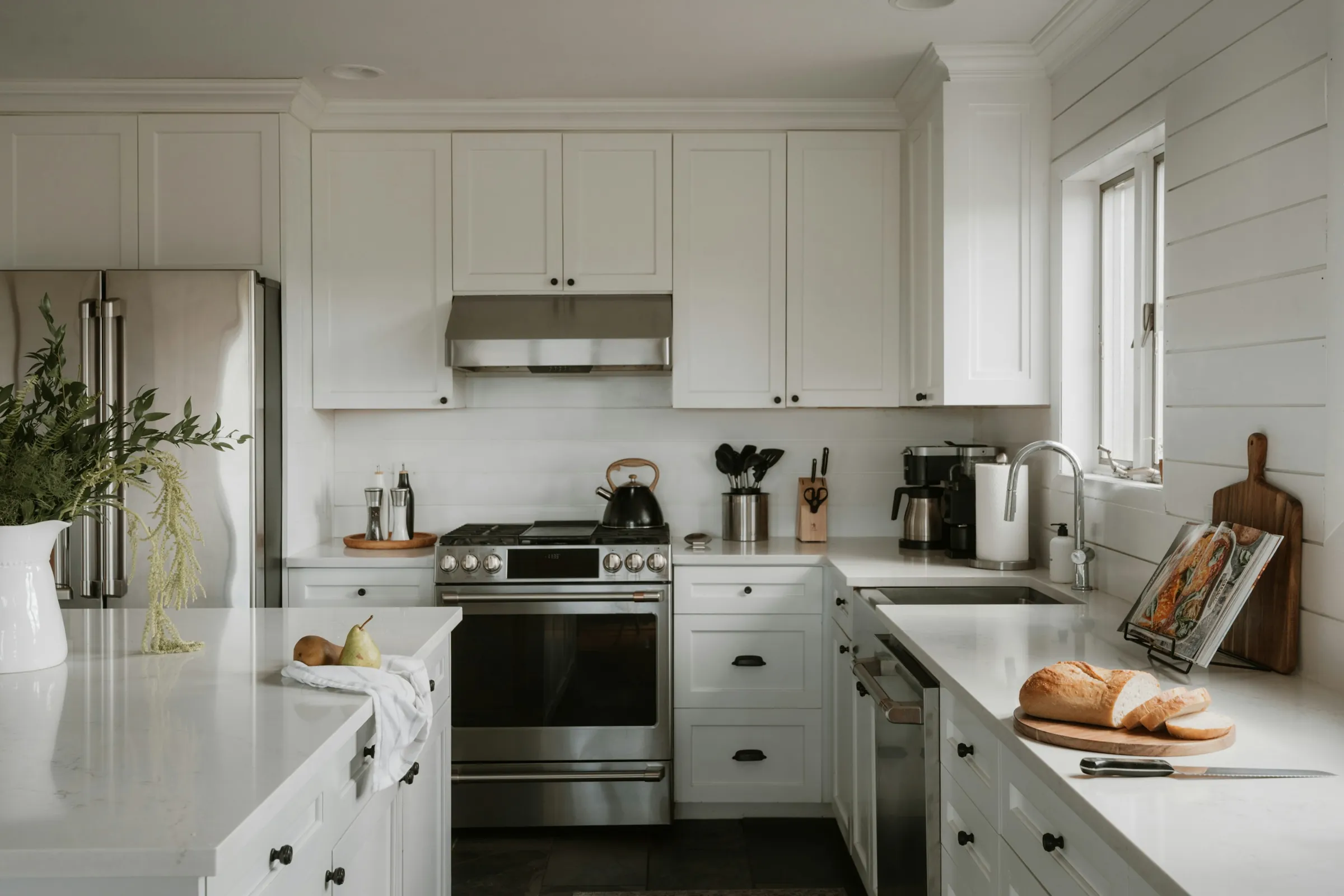 A bright white kitchen with shaker cabinets